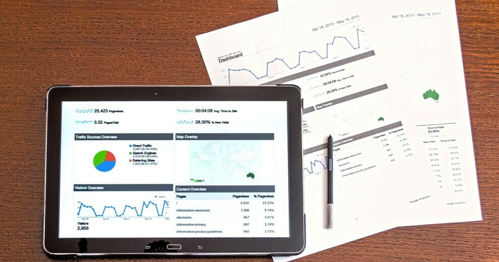 table showing investment performance beside a paper report