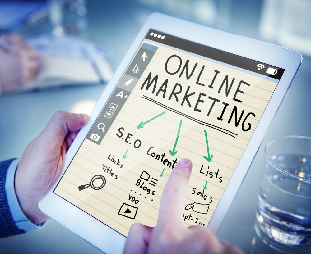 tablet photo showing a paper with online marketing written on it, with arrows pointing to SEC and content