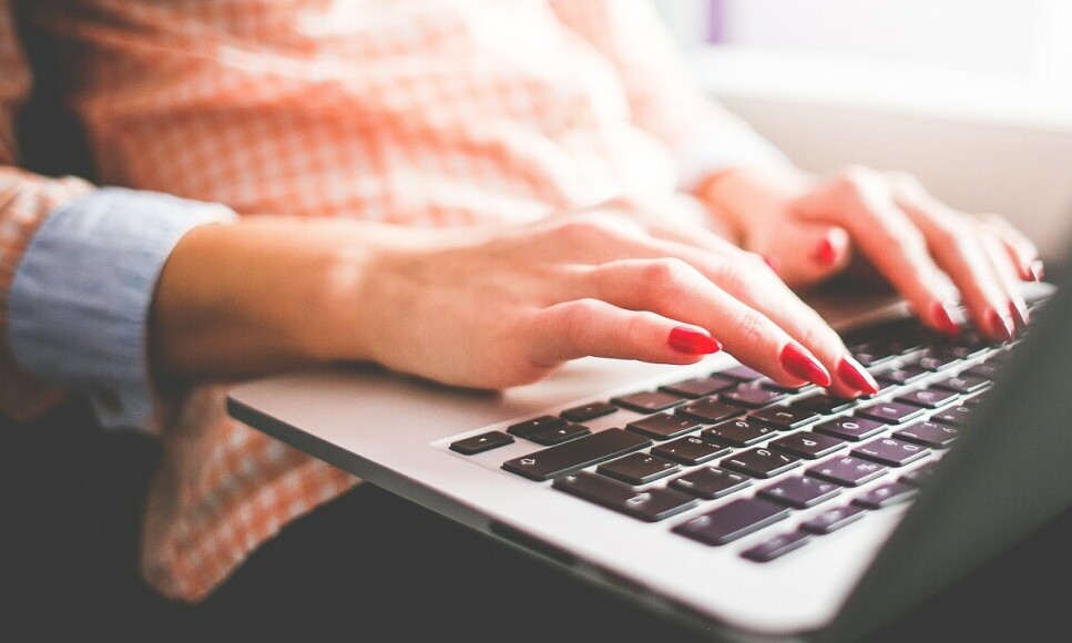 ladies hand typing on a keyboard